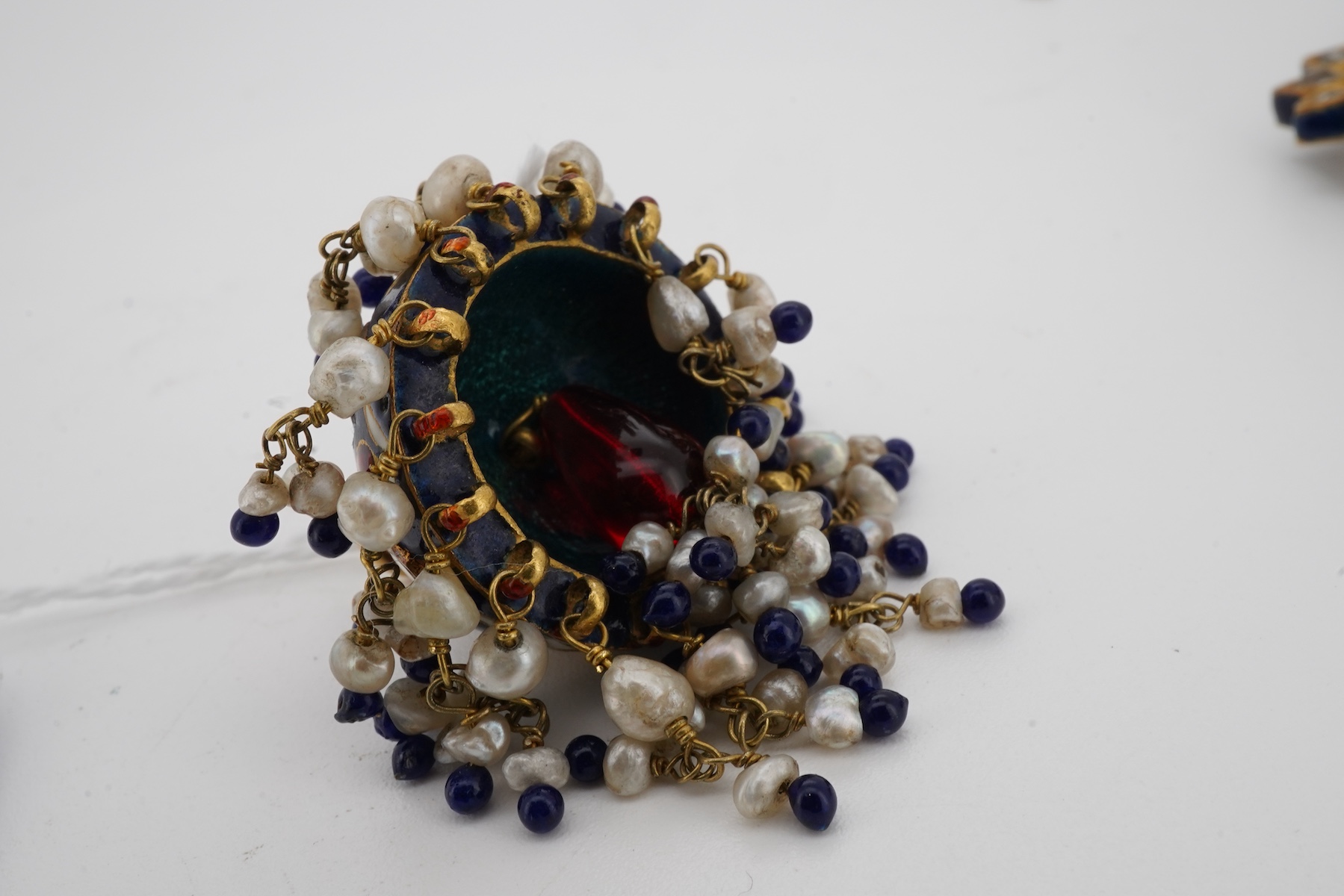 Two pairs of Indian enamelled earrings, comprising: one of chandelier design, set with rock crystals and applied with blue, white and red enamel, suspending a fringe of cultured pearls and blue and red pastes, length 5.1